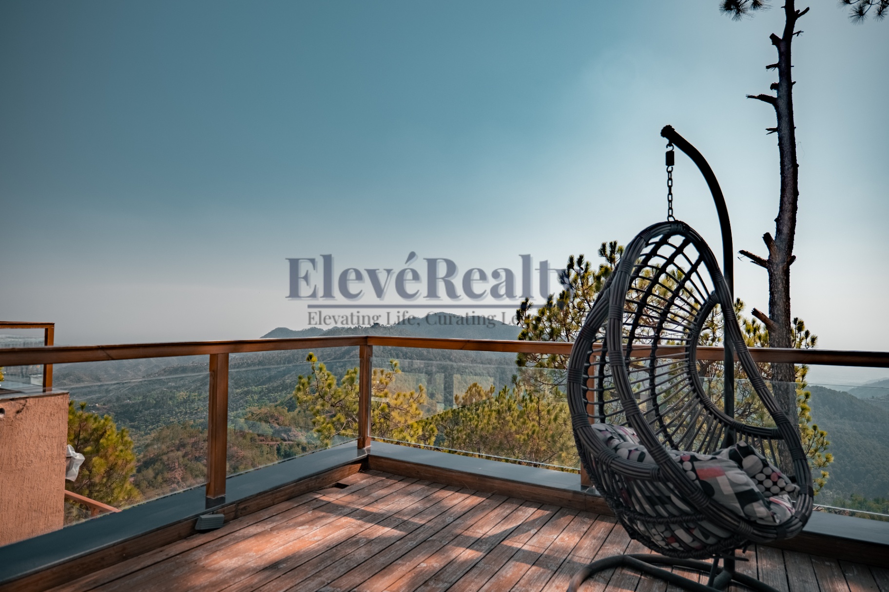 Private balcony with cane seating overlooking pine ridges