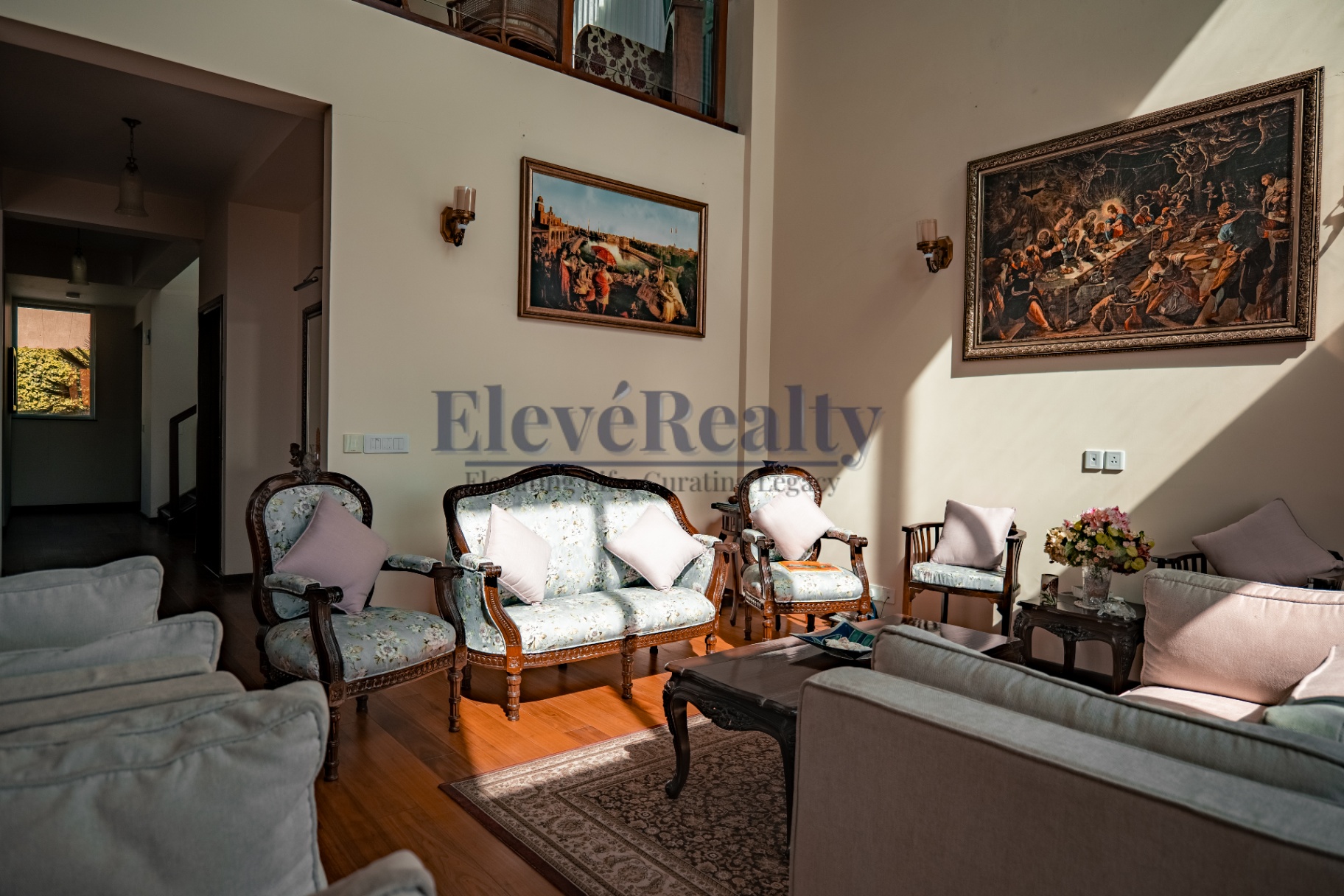 Living room with heritage seating and double-height volume
