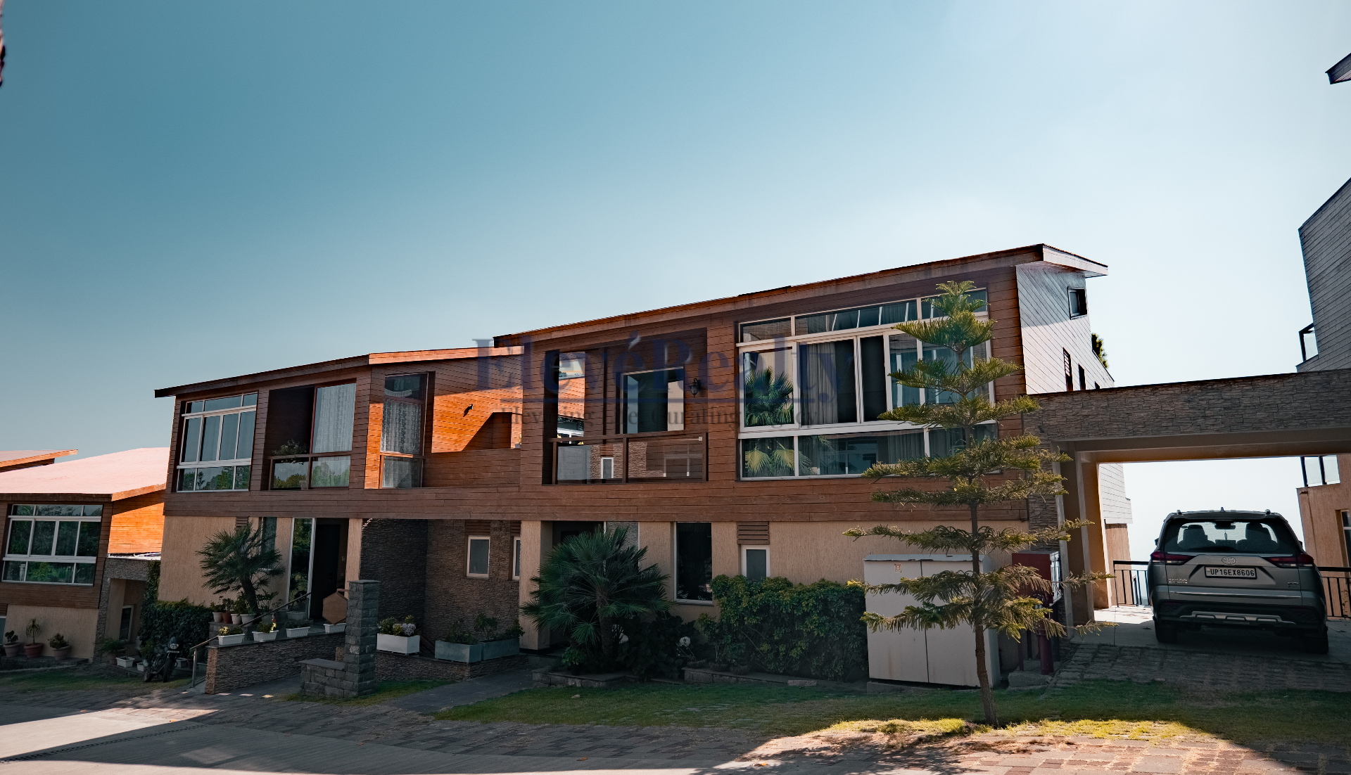 Wide exterior view of the villa and driveway