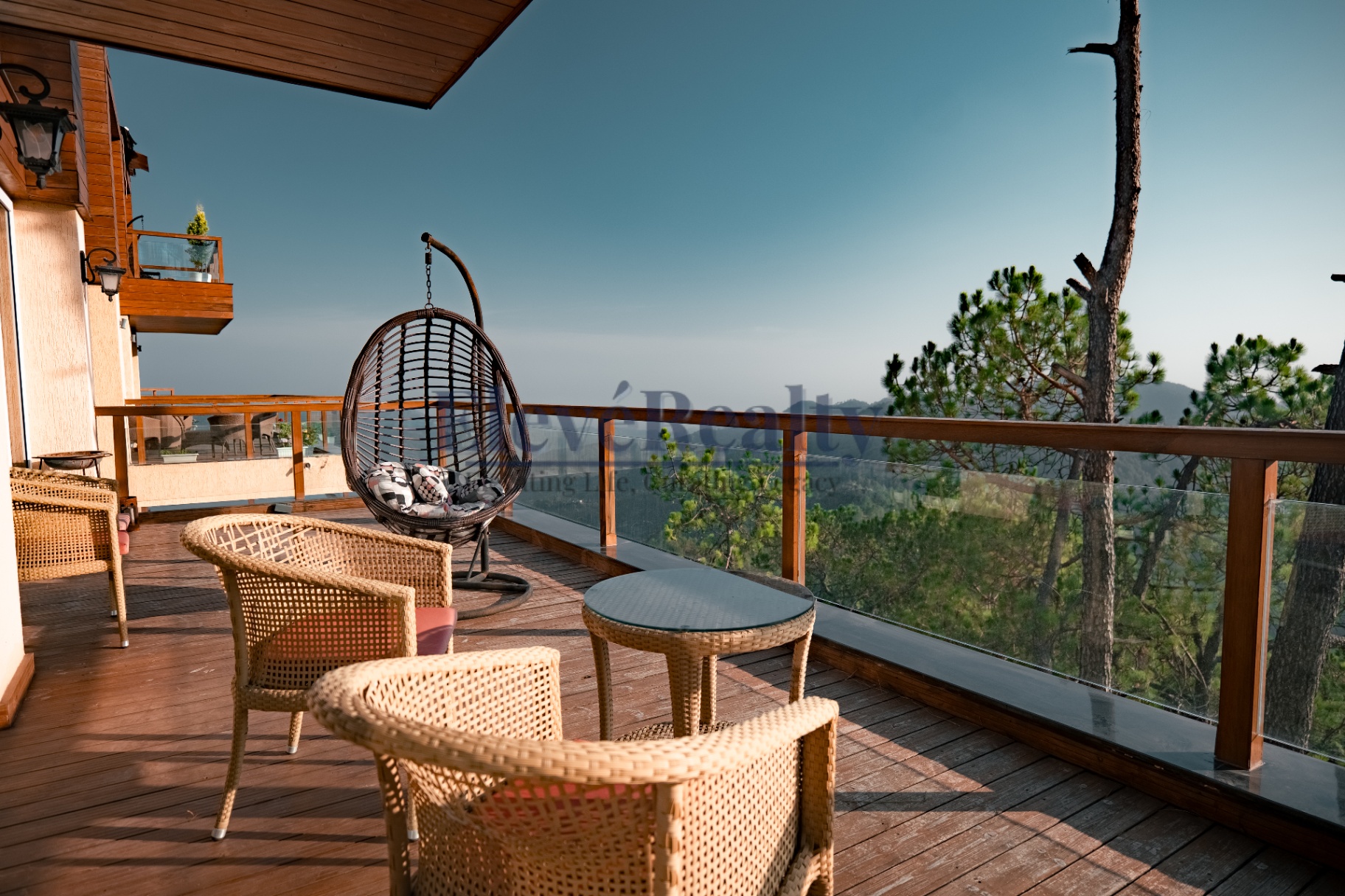 Expansive wooden deck with lounge chairs and hanging seat