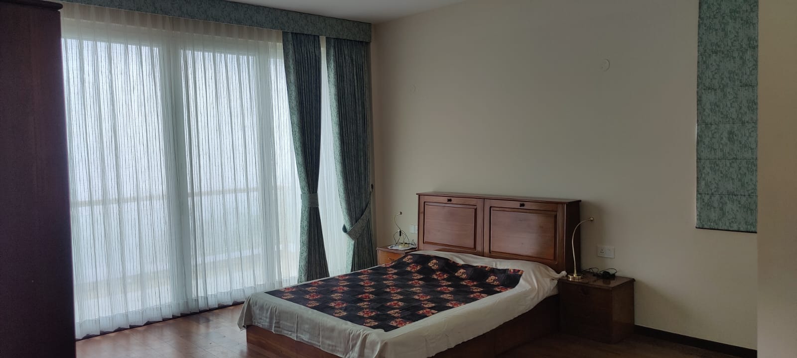Master bedroom with sheer curtains and ridge view